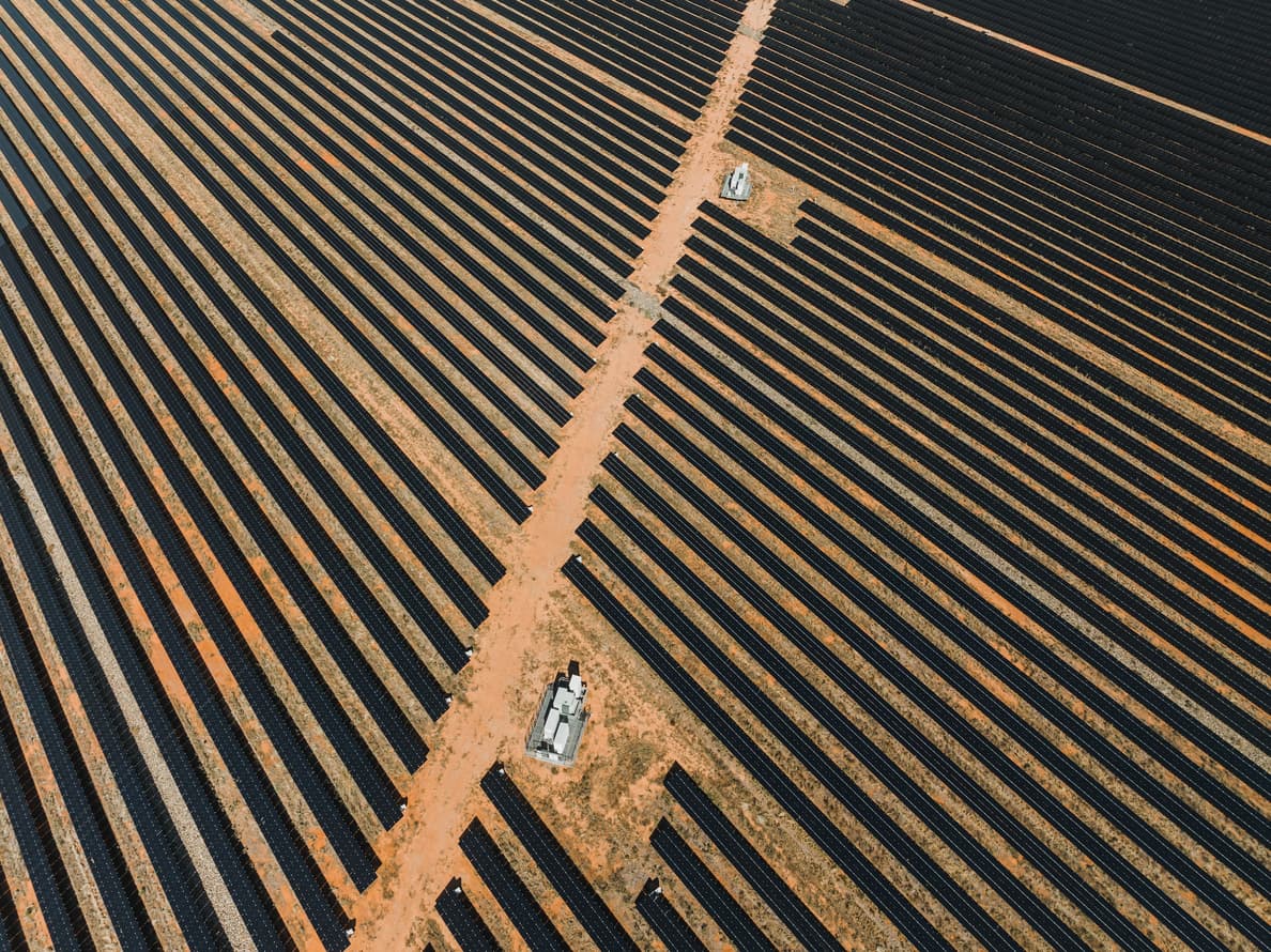 An aerial view of solar panels in a field.
