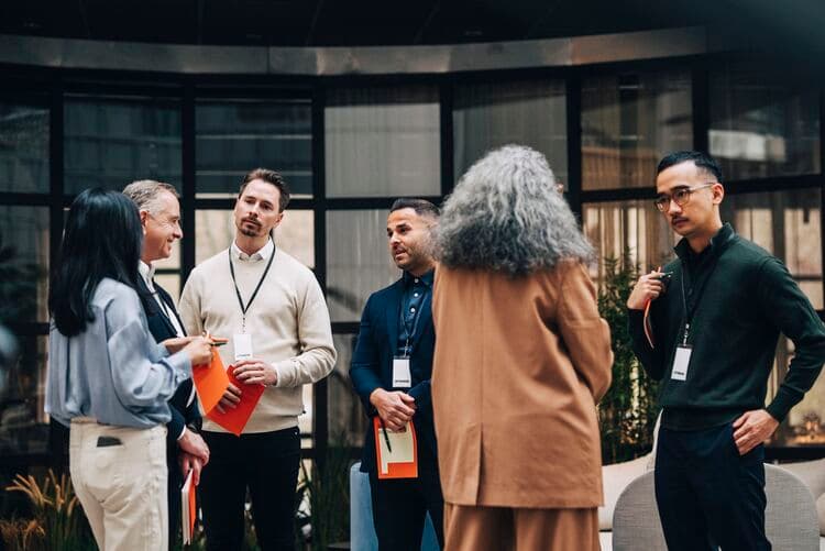 A group of professional people in conversation at an event